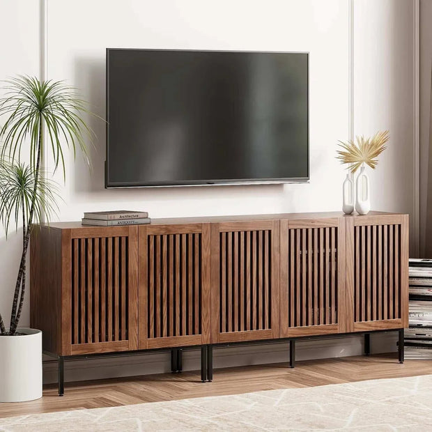 Farmhouse TV stand with storage cabinets and metal base in a living room.