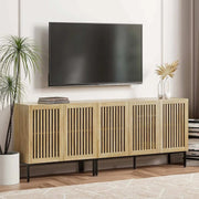 Farmhouse TV stand with grating door design, ample storage, and metal base in a modern living room setting.
