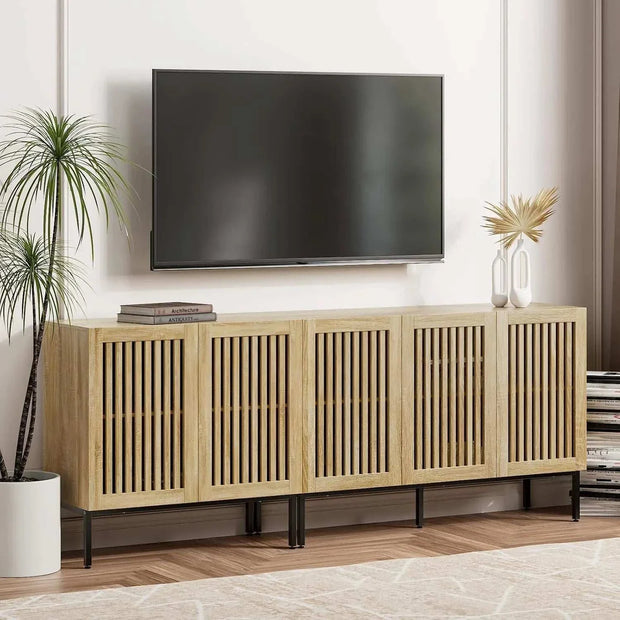 Farmhouse TV stand with grating door design, ample storage, and metal base in a modern living room setting.