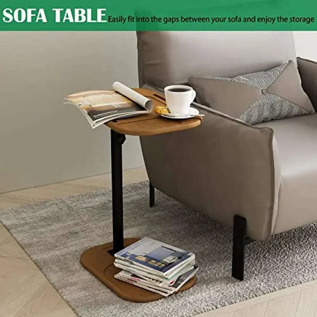 Adjustable height C-shaped end table beside a sofa with books and a coffee cup, modern design, wood and metal construction.